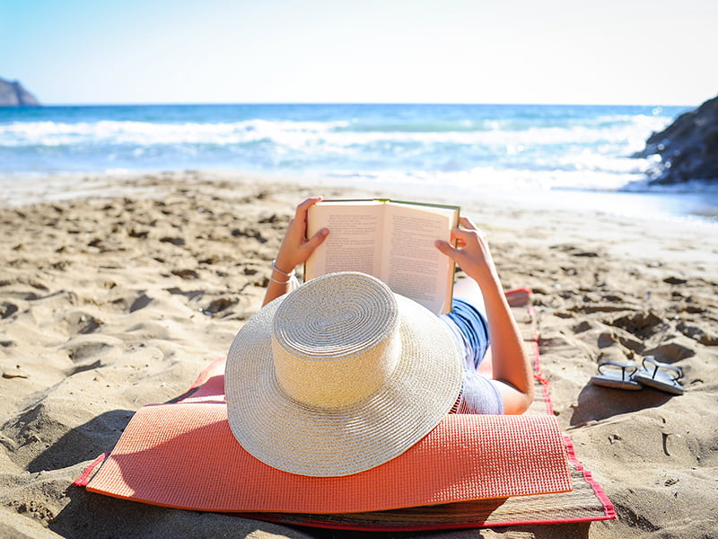 lady reading on beach